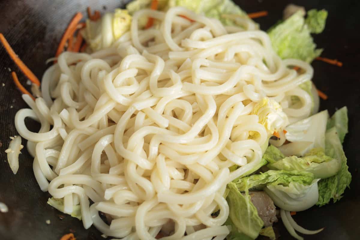 Udon noodles in wok.