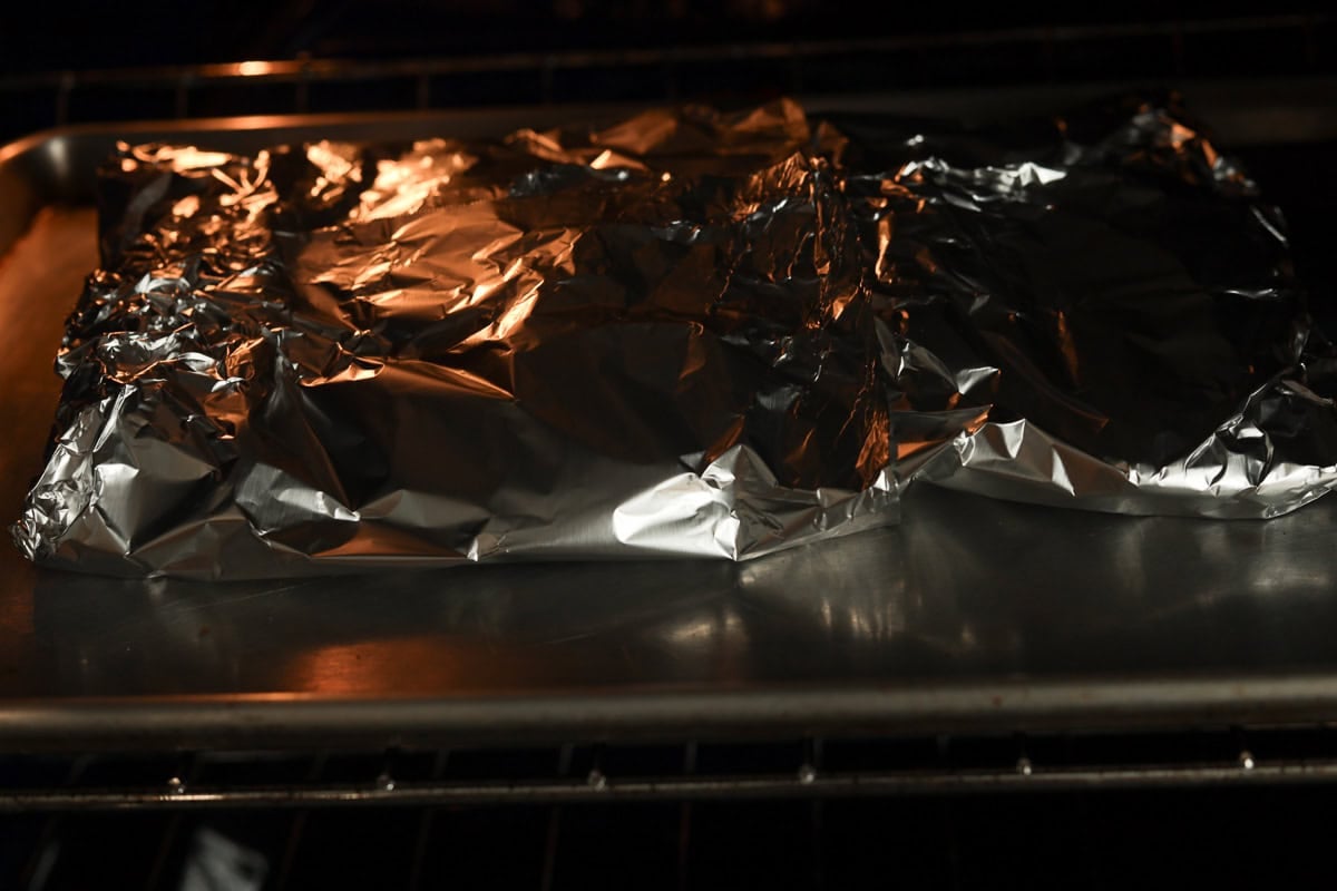 Foil covered beef ribs in oven.