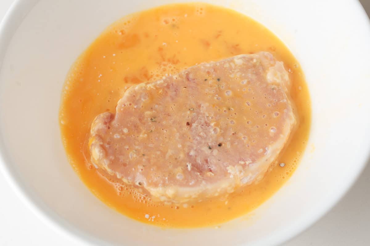 Pork cutlet in egg wash.