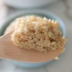 cooked brown rice on spoon.