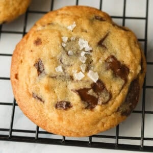 Dark chocolate chip cookie with sprinkled sea salt on top.