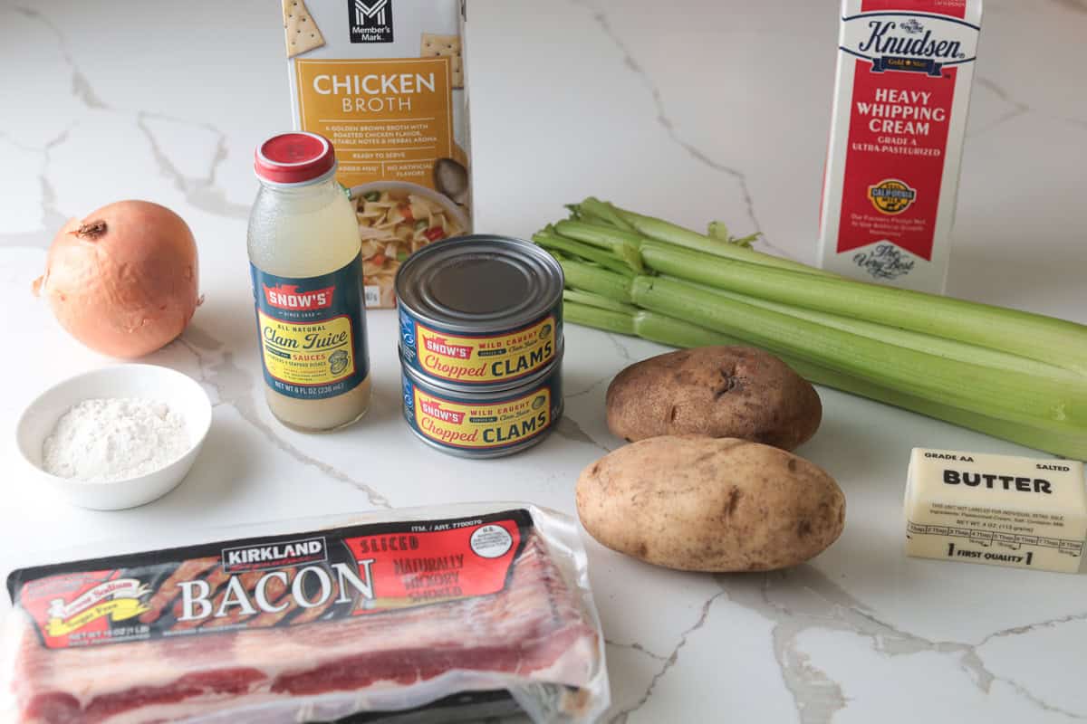 Ingredients for clam chowder including canned clams, clam juice, bacon, potatoes, celery, onion, broth, and whipping cream.