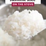 interest graphic featuring a scoop of fluffy cooked white jasmine rice on a paddle over a stainless steel pot, with text reading "HOW TO COOK JASMINE RICE ON THE STOVE" and website link "www.apeachyplate.com".