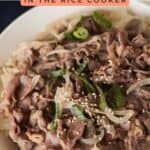 Pinterest graphic titled "BEEF GYUDON IN THE RICE COOKER" featuring a close-up bowl of thinly sliced beef, onions, green onions, and sesame seeds over rice, with "www.apeachyplate.com" at the bottom.